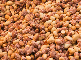 Close up macro salted peeled peanuts background.