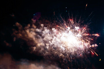 Bright light flash of fireworks, against the background of the night sky.