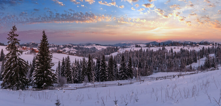 Small and quiet alpine village and winter sunrise snowy mountains around, Voronenko, Carpathian, Ukraine.