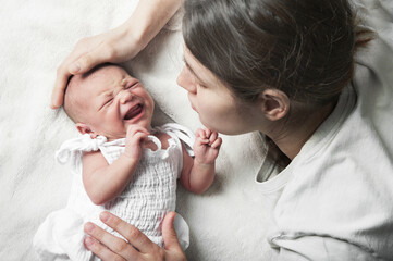 Newborn crying, sleep of children. Tired Mother with Upset Baby Suffering with Post Natal Depression