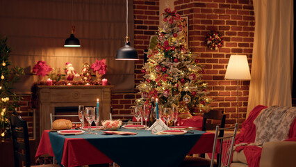Cozy and warm looking dining room with seasonal and positive style with nobody in it. Empty interior of festive traditional Christmas dinner table with authentic decorations and dinnerware.