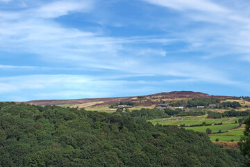 view of the village of midgley moor surrounded by farmhouses and pennine countryside in summer...