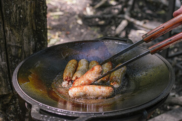 sausages fried in a cauldron