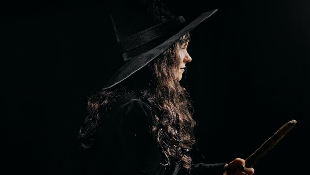 Beautiful witch with long hair flying on broom at night. Halloween masquerade costume, party decoration. Magic, classic hag