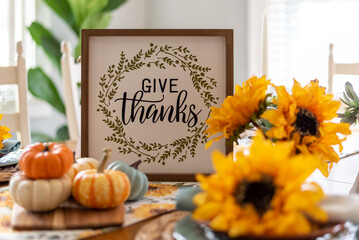 Give Thanks Sign on a Dining Table Decorated for Autumn