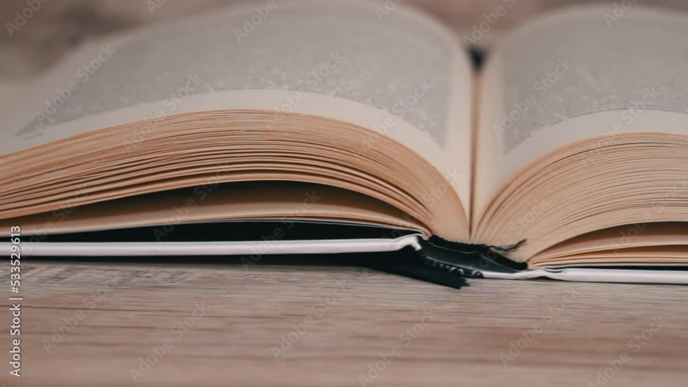Poster turning pages in a white book close up slow mo. reading a book, intelligence. pages flow one after a