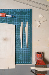 detail of pieces of wood and carpenter's hand tools on table
