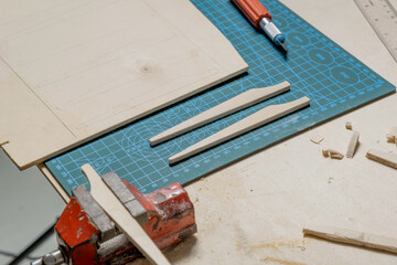 detail of pieces of wood and carpenter's hand tools on table
