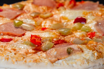 Baked pizza with with sausage, mushroom, pepper, cheese on tray in electric oven - close up. Italian cuisine fast food, homemade bakery concept