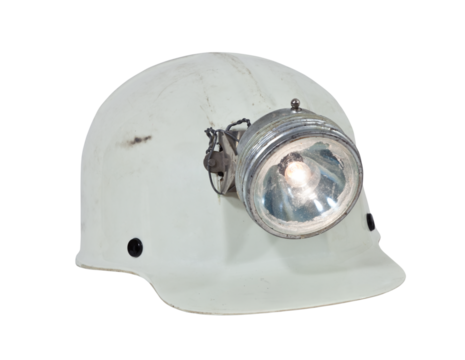 Vintage caving and mining hard hat with lamp isolated.