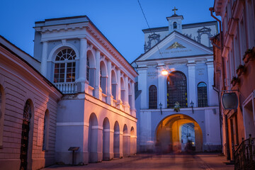 Fototapeta na wymiar Vilnius old town, gates of dawn street illuminated at night, Lithuania
