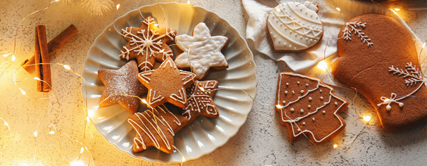 Christmas composition with tasty gingerbread cookies on light background
