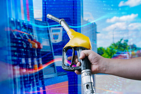 A man fills up a car at a gas station on technological background. Graph of rising prices for gasoline and fuel.