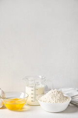 Different ingredients for baking on table against white background