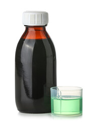 Bottle of cough syrup and cup on white background