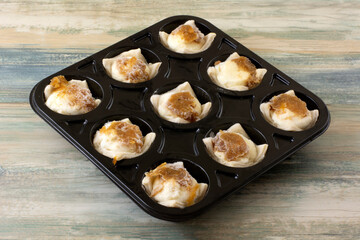 Frozen caramelized onion and feta and cream cheese appetizers in black plastic packaging