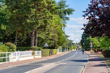 The road passing through the city of Merville-Franceville Plage, the beginning of the entrance to the city. Normandy, France.