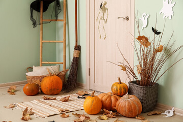 Interior of hall with pumpkins, fallen leaves and Halloween decor