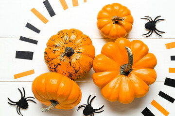 Halloween pumpkins with spiders on white wooden background