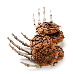 Halloween spiderweb cookies and skeleton hands on white background