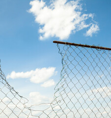 Broken metal mesh fence
