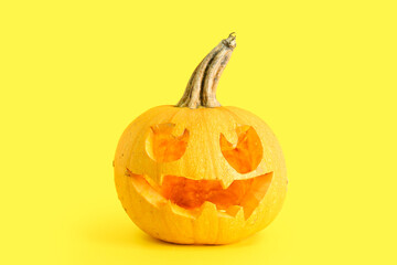 Jack-O-Lantern pumpkin on yellow background
