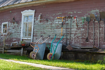 Installation set of antique objects on the wall of a wooden house