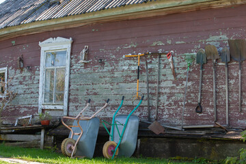 Installation set of antique objects on the wall of a wooden house