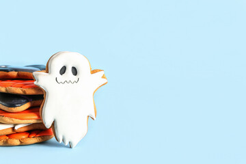 Tasty Halloween cookies on blue background
