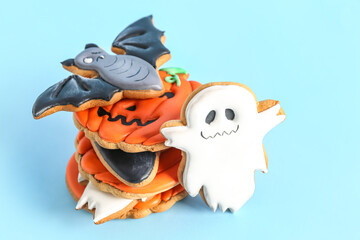 Tasty Halloween cookies on blue background