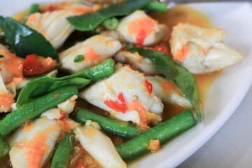 Spicy crab stir fry with basil and yellow chili on white plate.  Asia Thai famous cuisine. healthy seafood.