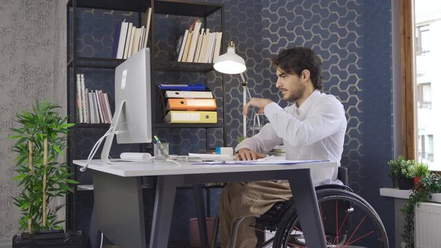 Disabled businessman working in the office is angry.
Frustrated disabled businessman gets angry at desk.
