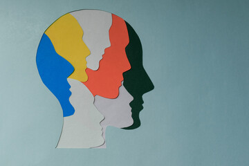 paper cut style Colored silhouette faces in head. Metaphor bipolar disorder,  Parkinson, Double face, Split personality, Psychology, Dual personality Mental health concept. Copy space. - obrazy, fototapety, plakaty