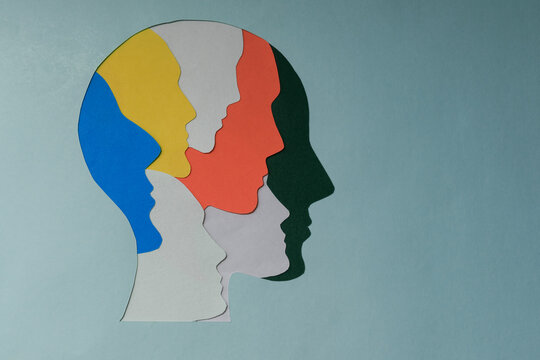 paper cut style Colored silhouette faces in head. Metaphor bipolar disorder,  Parkinson, Double face, Split personality, Psychology, Dual personality Mental health concept. Copy space.