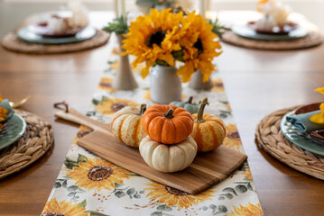 Fototapeta na wymiar Beautiful fall dining table with pumpkins and sunflowers