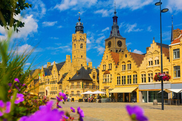 Market Square of Belgian city of Diksmuide with Gothic Town Hall and St Nicholas Church at summer day - obrazy, fototapety, plakaty