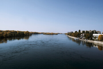 View of the city of Ust-Kamenogorsk (kazakhstan). Old residential area. Soviet built multistory apartment buildings. Irtysh river. Autumn. Fall. Yellow trees and Blue sky