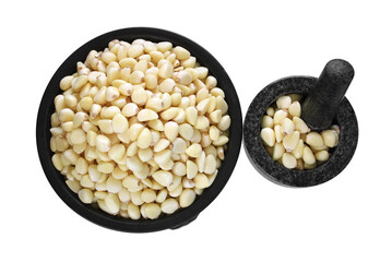 Freshly peeled garlic in the pottery and stone mortar isolated on white background. 