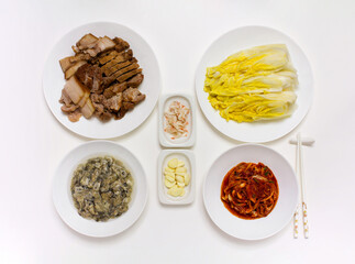 Korean traditional food. Ingredients of Kimchi mixed seasoning, raw oyster, boiled pork Slices and salt pickled cabbages.