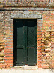 Old wooden door in a house in burano Island