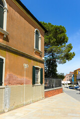 Fototapeta na wymiar Traditional vintage windows with old house in Burano island, Venice, Italy.
