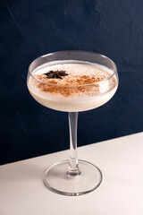 Homemade Eggnog with cinnamon and nutmeg in martini glass.