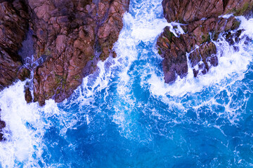Aerial view of waves crashing on rocks,Seascape with birds eye view shot over ocean waves image for...