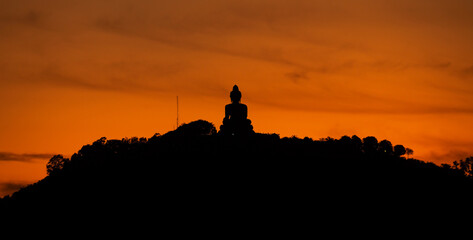 Silhouette of big buddha on high mountain in Phuket Thailand,Amazing light of sunset nature Landscape nature background