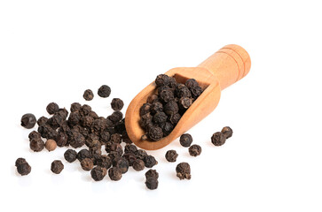 Black pepper on a wooden scoop isolated on white background.