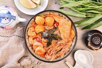 Singapore laksa - spicy noodle soup with noodles, prawns,  chicken, tofu, fishball served in spicy curry coconut milk 