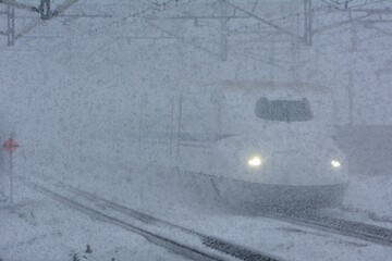 Tokaido Shinkansen N700A passing through Maibara station at snowy day