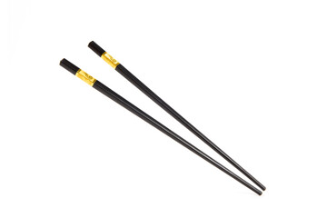 black chopsticks with golden ornamentation isolated on white background