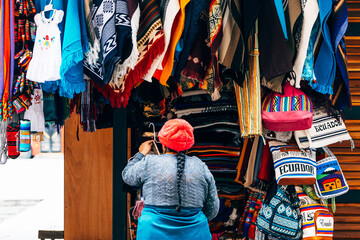 colorful bags are displayed in otavalo market, ecuador