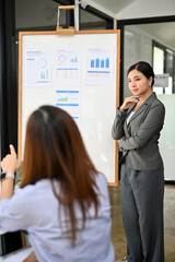 Confident Asian businesswoman or financial analyst manager leads the financial meeting
